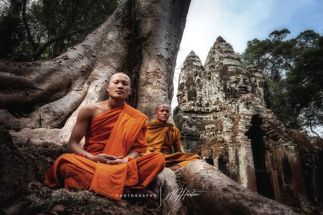 Monks meditate at the North Gate of Angkor T